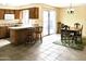 Kitchen flows into a dining area, with bar seating and sliding glass doors to a backyard at 3817 W Caron St, Phoenix, AZ 85051