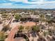 Expansive aerial view of a desert estate featuring mature landscaping, a circular driveway and beautiful desert surroundings at 4115 E Ashler Hills E Dr, Cave Creek, AZ 85331