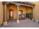 Inviting front porch featuring brick pavers, wooden support beams, and charming outdoor decor at 4115 E Ashler Hills E Dr, Cave Creek, AZ 85331