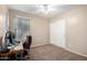 Serene bedroom features a built-in closet, a study desk, carpeted floors, and neutral decor at 41655 W Somerset Dr, Maricopa, AZ 85138