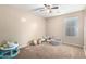 Bright bedroom with neutral tones, carpet, and a window for natural light, ideal for or play at 41655 W Somerset Dr, Maricopa, AZ 85138