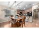 A dining area adjacent to the kitchen features an island bar and a modern light fixture at 41655 W Somerset Dr, Maricopa, AZ 85138