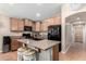 Kitchen island with seating, granite countertops, and stainless steel appliances at 41655 W Somerset Dr, Maricopa, AZ 85138
