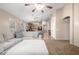 Cozy living room with plush sectional sofa, open to kitchen and dining areas at 41655 W Somerset Dr, Maricopa, AZ 85138