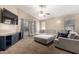 Living room with plush seating, TV, and neutral carpet at 41655 W Somerset Dr, Maricopa, AZ 85138