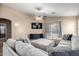 Comfortable living room with a large sofa, TV, and a view to the backyard at 41655 W Somerset Dr, Maricopa, AZ 85138