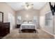 Spacious main bedroom features a ceiling fan and lots of natural light at 41655 W Somerset Dr, Maricopa, AZ 85138