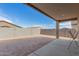 View of the backyard with block wall fence and covered patio at 4402 W Bush Bean Way, San Tan Valley, AZ 85144