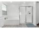 Bright bathroom featuring a soaking tub and glass-enclosed shower at 4402 W Bush Bean Way, San Tan Valley, AZ 85144