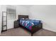 Bright bedroom with a dark bed frame and natural light from the window at 4402 W Bush Bean Way, San Tan Valley, AZ 85144