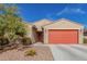 Charming single-story home with desert landscaping, a red garage door, and a matching front door at 4402 W Bush Bean Way, San Tan Valley, AZ 85144