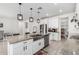 Well-lit kitchen with stainless steel appliances, spacious island with sink, and walk-in pantry access at 4402 W Bush Bean Way, San Tan Valley, AZ 85144