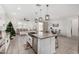 Open-concept kitchen with island, stainless steel appliances, and easy access to dining and living areas at 4402 W Bush Bean Way, San Tan Valley, AZ 85144