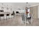 Open-concept living space with tile floors, ceiling fans, and an adjacent kitchen and dining area at 4402 W Bush Bean Way, San Tan Valley, AZ 85144