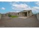 Spacious backyard with gravel landscaping and a covered patio with outdoor seating at 4609 S 122Nd S Dr, Avondale, AZ 85323