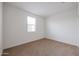 Cozy bedroom featuring neutral carpet and a large window for natural light at 4609 S 122Nd S Dr, Avondale, AZ 85323