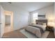 Comfortable bedroom with neutral carpet, closet doors, and a cozy bed, offering a serene retreat at 4609 S 122Nd S Dr, Avondale, AZ 85323