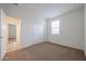 Cozy bedroom with carpet flooring, closet, and a window providing natural light and an airy ambiance at 4609 S 122Nd S Dr, Avondale, AZ 85323