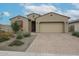 Charming single-story home featuring a brick driveway, two car garage and low maintenance desert landscaping at 4609 S 122Nd S Dr, Avondale, AZ 85323