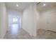 Bright hallway features neutral tile flooring and gives access to a den/office and the main living space at 4609 S 122Nd S Dr, Avondale, AZ 85323