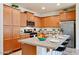 Well-equipped kitchen featuring stainless steel appliances, granite countertops, and light wood cabinetry at 4609 S 122Nd S Dr, Avondale, AZ 85323