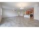 Bright living room featuring an open floor plan with gray tile flooring and a combined kitchen area at 4609 S 122Nd S Dr, Avondale, AZ 85323