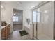 An ensuite bathroom featuring a shower and soaking tub with wood cabinets and tile floors at 4609 S 122Nd S Dr, Avondale, AZ 85323