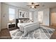 Comfortable main bedroom with ample natural light, ceiling fan, and adjacent bathroom at 4609 S 122Nd S Dr, Avondale, AZ 85323