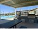 An amazing outdoor kitchen area is poolside and has picnic tables with a cooking area at 4609 S 122Nd S Dr, Avondale, AZ 85323