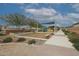 Community playground with swings, a covered seating area, and a walking path at 4609 S 122Nd S Dr, Avondale, AZ 85323