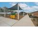 Community playground featuring play structures, covered seating, and easy sidewalk access at 4609 S 122Nd S Dr, Avondale, AZ 85323
