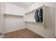 A walk-in closet featuring built-in shelving and hanging rods for efficient storage at 4609 S 122Nd S Dr, Avondale, AZ 85323