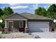 Charming single-story home with stone accents, desert landscaping, and a two-car garage at 6130 E Artemis Dr, Florence, AZ 85132
