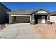 Single-story home under construction with an attached garage and concrete driveway at 6130 E Artemis Dr, Florence, AZ 85132