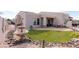 Outdoor patio, fountain, and synthetic grass create an inviting backyard oasis at 6202 E Mckellips Rd # 210, Mesa, AZ 85215
