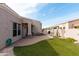Private backyard with covered patio, synthetic grass, and desert landscaping at 6202 E Mckellips Rd # 210, Mesa, AZ 85215