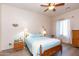 Cozy bedroom with ceiling fan, wooden furnishings, and natural light provides a serene space at 6202 E Mckellips Rd # 210, Mesa, AZ 85215