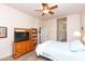 Spacious bedroom features ceiling fan, dresser, and ample closet space; bright and airy at 6202 E Mckellips Rd # 210, Mesa, AZ 85215