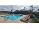 Resort-style community pool with lounge chairs and lush landscaping at 6202 E Mckellips Rd # 210, Mesa, AZ 85215