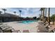 Community pool and clubhouse area with lounge chairs and palm trees at 6202 E Mckellips Rd # 210, Mesa, AZ 85215