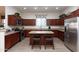 Well-lit kitchen featuring stainless steel appliances, a granite island, and ample cabinet space at 6202 E Mckellips Rd # 210, Mesa, AZ 85215