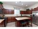 Bright kitchen with stainless steel appliances, granite counters, an island and ample storage at 6202 E Mckellips Rd # 210, Mesa, AZ 85215