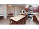Spacious kitchen featuring an island, stainless steel appliances, and seamless transition to dining space at 6202 E Mckellips Rd # 210, Mesa, AZ 85215