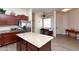 Open kitchen with an island, stainless steel appliances, and seamless transition to dining space at 6202 E Mckellips Rd # 210, Mesa, AZ 85215