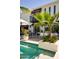 Outdoor living area with pool, patio furniture, and beautiful landscaping for relaxation and entertainment at 7242 E Joshua Tree Ln, Scottsdale, AZ 85250