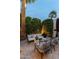 Cozy backyard patio with modern outdoor furniture, privacy landscaping and contemporary art at 7242 E Joshua Tree Ln, Scottsdale, AZ 85250