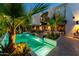 Outdoor living space featuring a sparkling pool, manicured landscaping and outdoor dining at 7242 E Joshua Tree Ln, Scottsdale, AZ 85250