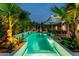 A beautiful rectangular pool featuring modern planters, manicured landscaping and sconce fountains at 7242 E Joshua Tree Ln, Scottsdale, AZ 85250
