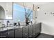Elegant bathroom featuring a double vanity with black marble countertop, modern fixtures, and stylish decor at 7242 E Joshua Tree Ln, Scottsdale, AZ 85250