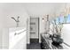 Well-lit bathroom with a modern vanity, marble countertop, stylish decor, and a spacious shower area at 7242 E Joshua Tree Ln, Scottsdale, AZ 85250